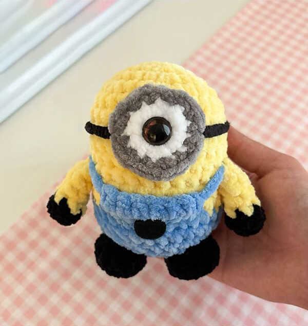 Free Crochet Minion Pattern: The final result of our adorable amigurumi project. This handmade minion is a perfect DIY gift for kids.