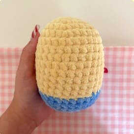 This frame shows the yellow head and body pieces which are the foundation of your project. Although there is a real free pattern in the link, this image serves as a visual representation of the base structure. You should visit our blog to start crafting your handmade Minion today.