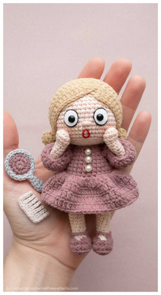 Crochet doll wearing a pink kimono style dress with floral headpiece, perfect as a unique handmade gift for girls