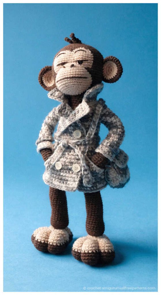 Stylish crochet monkey dressed in a gray coat with handbag, unique monkey amigurumi design inspiration for handmade decor