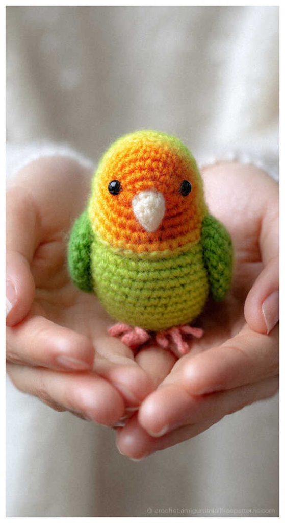 Tiny colorful crochet parrot held in hands, sweet parrot amigurumi gift idea for kids and nursery decor